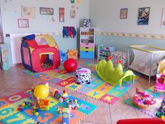 a child's playroom with toys and other items on the floor in it