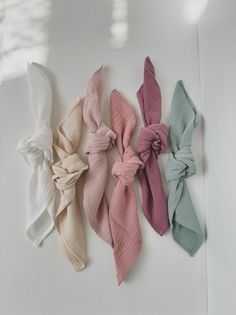 four different colored hair ties on a white surface