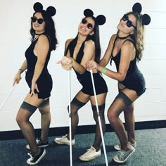 three women dressed up in mickey mouse costumes