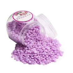 small purple beads in a jar on a white background