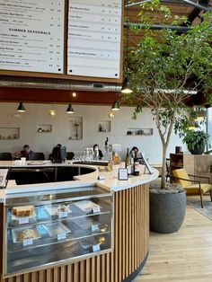 the inside of a restaurant with tables, chairs and menus on the wall above it