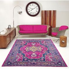 a living room filled with furniture and a pink rug