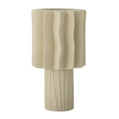 a tall white vase with wavy lines on the top and bottom, sitting in front of a white background