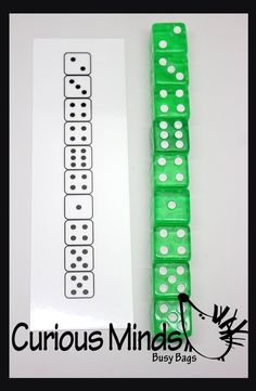 two green dices sitting next to each other on top of a piece of paper