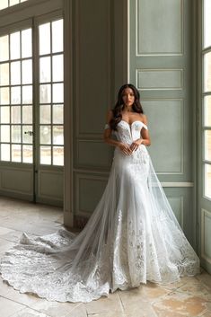 a woman in a wedding dress posing for the camera