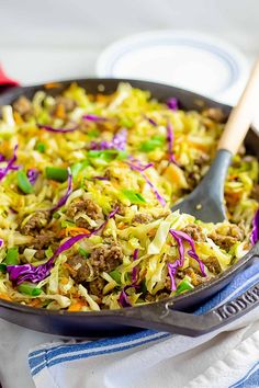 a skillet filled with coleslaw and meat