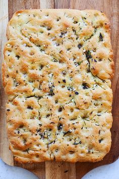 a loaf of bread on top of a wooden cutting board