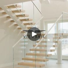 a staircase with glass railing and wooden steps