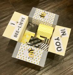 several small boxes are stacked on top of each other, with bees and chevron stripes