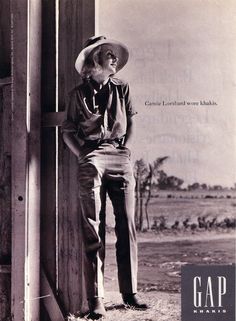 an old photo of a man wearing a cowboy hat leaning against a wall with his hands on his hips