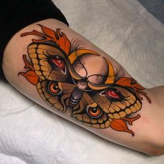 a close up of a person's leg with a butterfly tattoo design on it