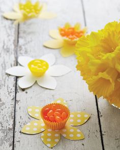 yellow and white flowers are sitting on a table