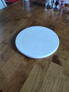 a white plate sitting on top of a wooden table