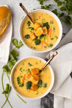 two bowls of soup with broccoli, cauliflower and croutons