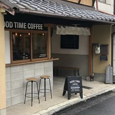 an outside view of a coffee shop with two stools and a sign that says good time coffee