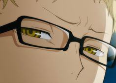 a man with glasses and yellow eyes stares at the camera while wearing black rimmed glasses