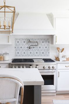 a kitchen with white cabinets and an oven