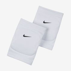 two white nike tennis knee pads with black nike logo on the front and back side