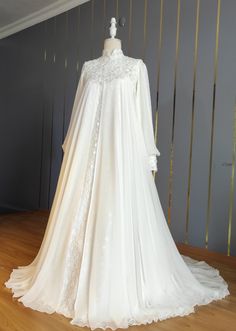 a white wedding gown on display in a room