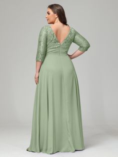 a woman in a long green dress with an open back and lace detailing on the shoulders