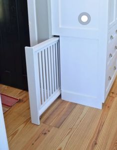 a white cabinet and drawers in a room