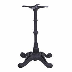 a black metal table with an iron cross on it's top and two legs