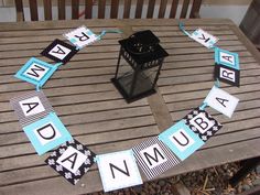 a table that has some signs on it and a lantern in the middle of it