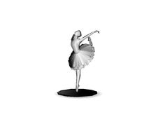 a white ballerina figurine on a black base with one leg bent forward