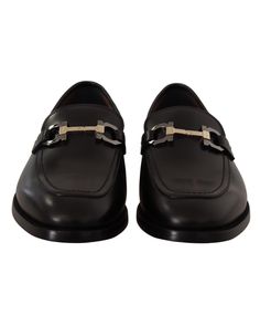 a pair of black shoes with metal straps