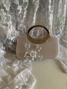 "Beautiful fall bag, amazing details, handmade satin flowers with pearls and crystals. Dimensions: 8\"long x 6.5\" high x 2\" deep NO RETURNS, NO EXCHANGE, PLEASE CONTACT FOR ANY ADDITIONAL QUESTIONS." Beige Pearl Embellished Evening Bag For Wedding, Wedding Embellished Pearl Evening Bag, Elegant Satin Wedding Bag, Beige Pearl Evening Bag For Wedding, Pearl White Evening Bag With Pearl Handle For Wedding, Cream Pearl Evening Bag For Wedding, Rectangular Satin Wedding Bag, Embellished Cream Evening Bag For Wedding, White Pearl-embellished Bag For Wedding Guest