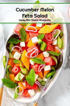 a white bowl filled with watermelon, cucumber, and mint salad