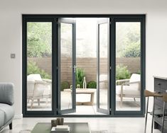 a living room filled with furniture and sliding glass doors