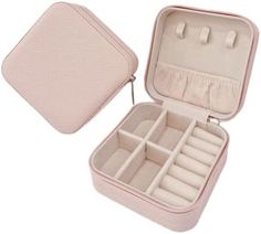 an open pink case with compartments for jewelry