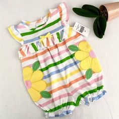 This Good Lad's Striped Romper Is Perfect For Your Little One. Featuring Multi-Color Stripes In Pink, Blue, Green, Orange Over White, And Is Lovingly Adorned With A Lovely Yellow Flower Applique. Size: 6m. Romper Size: Baby 6m Condition: New With Tags Brand: Good Lad Color: Multi-Color Stripes Size: 6m Style: Romper Material: 100% Cotton Adorned With A Yellow Flower Applique Features: Button Up In Back And Snap Closed Bottom Sleeveless Perfect For Backyard And Beach Play Made In Vietnam Machine Playful Spring Bubble Romper With Cartoon Print, Playful Multicolor Short Sleeve Onesie, Fall Onesie, Playful Yellow Long Sleeve Onesie, Playful Multicolor Printed Onesie, Playful Yellow Short Sleeve Onesie, Baby Boy Christmas Outfit, Toddler Girl Romper, Vest And Bow Tie