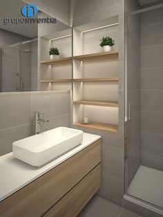 a white sink sitting under a mirror in a bathroom next to a walk in shower