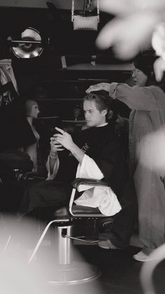 a black and white photo of a man sitting in a chair