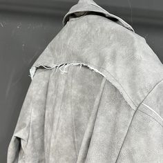 Step up your style with this gray distressed vegan leather trench coat. This coat combines a rugged, worn-in look with the luxury of high-end designer streetwear. Inspired by the edgy vibes of urban fashion and a Japanese folklore where distressed leather is believed to bring good luck, this loose-fit trench coat is both casual and comfortable, perfect for any occasion. This limited edition piece will transform your wardrobe and turn heads wherever you go. Why You'll Love It Vegan Leather: Ethical and luxurious material. Distressed Look: Trendy, rugged appeal. Luxury Designer Streetwear: High-end fashion for everyday wear. Loose Fit: Comfortable and easy to wear. Casual and Comfortable: Perfect for any occasion. Limited Edition: Exclusively available in select quantities. Size Chart Measur Distressed Leather Outerwear For Streetwear, Gray Leather Long Sleeve Outerwear, Gray Long Sleeve Leather Outerwear, Fall Gray Washed Outerwear, Casual Gray Leather Outerwear, Gray Leather Jacket For Fall, Edgy Vibes, Japanese Folklore, Designer Streetwear