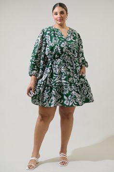 Step into the new season with this dreamy mini dress. It features long sleeves with a button placket in the front connecting to a belt tie around the waist, and ending in a mini hem. Wear it with white strappy heels to match. - Pockets- Drawstring waist- Button down- Ruffle layered- Color: Cream GreenSize + Fit - Model is 5'8" and wearing size XS- Measurements taken from size S - Chest: 27"- Length: 38 1/2" Fabric Self: 98% Polyester 2% Spandex, Lining: 97% Polyester 3% Spandex Style Number STD1 Green Floral Print Cotton Mini Dress, Green V-neck Printed Mini Dress, Cotton V-neck Mini Dress With Button Closure, Green Button-up Mini Dress With Button Closure, White Strappy Heels, Floral Print Cotton Button-up Shirt Dress, Belt Tie, One Shoulder Jumpsuit, Belt Tying