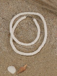 "This choker necklace features quality white shell heishi beads. The literal meaning of heishi (pronounced hee-shee) is \"shell\" and these beads are made using pieces of oyster shell (also known as mother-of-pearl) made into flat beads. A string of good heishi will have a uniform consistency in bead size and if you gently pull it through your hand, it should feel like a single serpent-like piece. When you look closely at each bead, you see the amazing detail and unique coloration of each bead. Pula Shell Necklace, Beach Jewelry With White Letter Beads, White Letter Beads Jewelry For Beach, White Beach Jewelry With Letter Beads, Beach Heishi Beads Single Strand Necklace, White Heishi Beads Necklace For Beach, White Jewelry With Letter Beads For Vacation, White Heishi Beads Strand Necklace, White Heishi Beads Single Strand Necklace