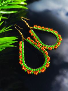 Cute handwoven beaded earrings with sunflowers.

Made of high quality Japanese beads.
(colors may vary due to your screen settings)
Earring hook made of brass.

Length- 6 centimeters
Width - 3 centimeters Traditional Green Teardrop Beaded Earrings, Traditional Green Handwoven Beaded Earrings, Handmade Bohemian Teardrop Earrings With Round Beads, Green Teardrop Beaded Earrings With Tiny Beads, Handmade Teardrop Beaded Festival Earrings, Handmade Teardrop Beaded Earrings For Festivals, Handmade Orange Teardrop Beaded Earrings, Traditional Teardrop Beaded Earrings With Tiny Beads, Sunflower Family