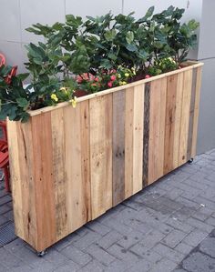 a wooden planter sitting on the side of a building