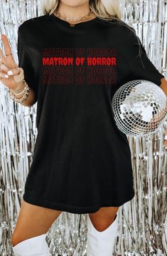 Planning a super spooky bridal shower or bachelorette? Then you need in on this eerily perfect matron of horror tshirt from our spooky bachelorette collection! Its a must have for any halloween or spooky inspired wedding this season! Check out the full collection here: * Made using the incredibly cozy and popular Comfort Colors tee and are UNISEX sizing.  * Please refer to the size charts we've included in our listing for sizing. If you have any questions about sizing or any other details, feel Spooky Bachelorette Party Outfits, Halloween Party Tops With Letter Print, Halloween Party Letter Print Tops, Spooky Bachelorette Party, Horror Tshirt, Spooky Wedding, Wedding Party Shirts, Proposal Wedding, Bachelorette Party Outfit