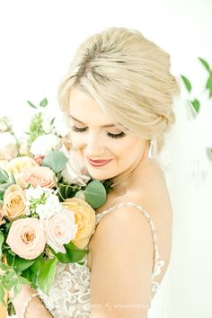 a bride holding a bouquet of flowers in her hands