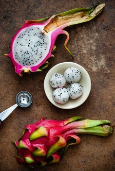 dragon fruit with seeds in a bowl and spoon next to it