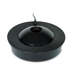 an empty black pot with a handle on the top and bottom, sitting on a white surface