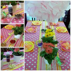 the table is set with pink and yellow plates, cups, vases and flowers