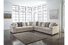 a living room with a sectional couch and rug