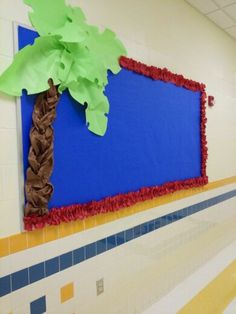 a palm tree on a bulletin board in a school hallway