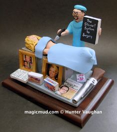 a figurine of a man laying on top of a bed holding a sign