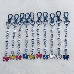 a bunch of key chains with butterflies on them